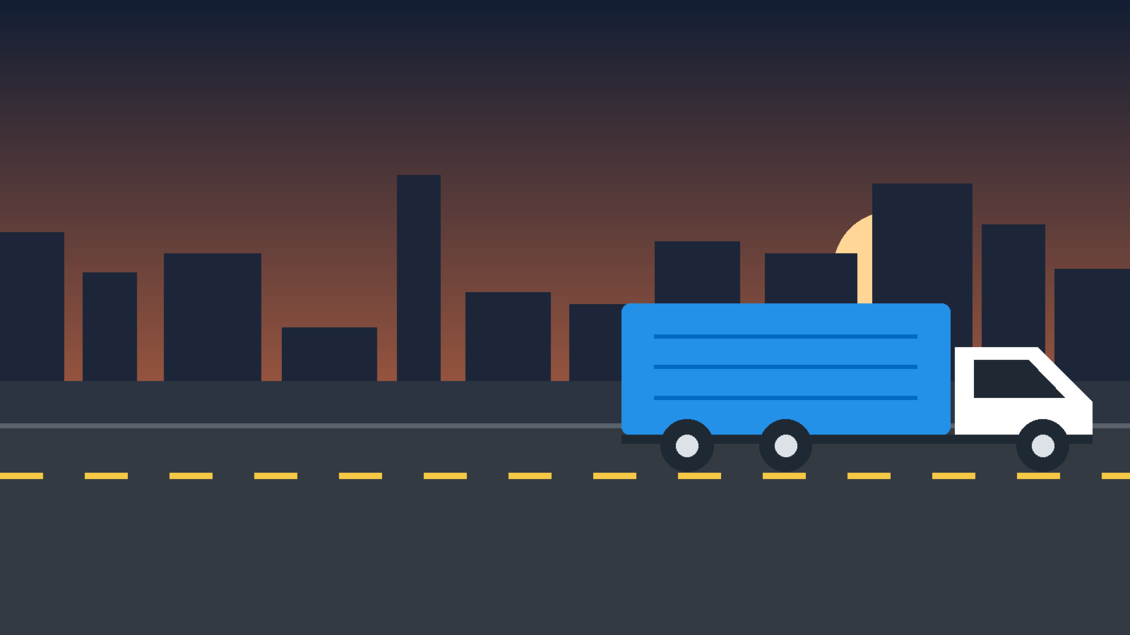 Truck on a highway at dusk with a city skyline